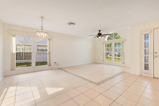 1002 Kelsey Ave, Oviedo, FL 32765 - spare room with baseboards, visible vents, light tile patterned floors, and ceiling fan with notable chandelier