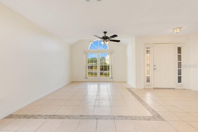 1002 Kelsey Ave, Oviedo, FL 32765 - empty room with baseboards, a ceiling fan, vaulted ceiling, and light tile patterned floors