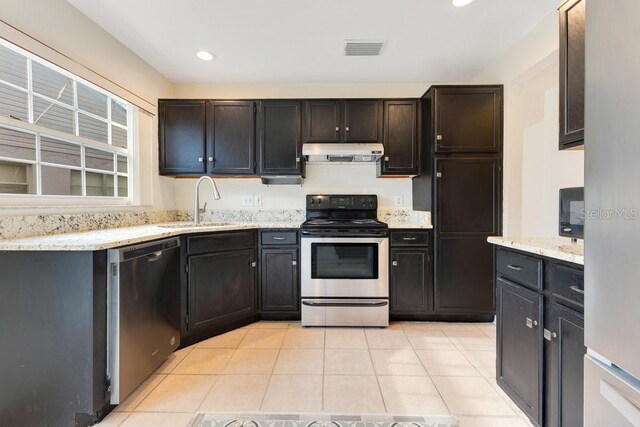 1002 Kelsey Ave, Oviedo, FL 32765 - kitchen featuring visible vents, appliances with stainless steel finishes, a sink, exhaust hood, and light tile patterned floors