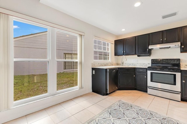 1002 Kelsey Ave, Oviedo, FL 32765 - kitchen featuring light tile patterned floors, stainless steel appliances, under cabinet range hood, a sink, and visible vents