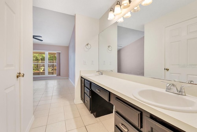 1002 Kelsey Ave, Oviedo, FL 32765 - bathroom featuring double vanity, lofted ceiling, a sink, and tile patterned flooring