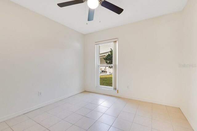1002 Kelsey Ave, Oviedo, FL 32765 - unfurnished room featuring light tile patterned flooring, baseboards, and ceiling fan