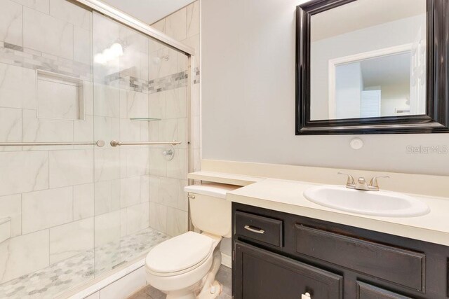 1002 Kelsey Ave, Oviedo, FL 32765 - bathroom featuring vanity, toilet, and a shower stall