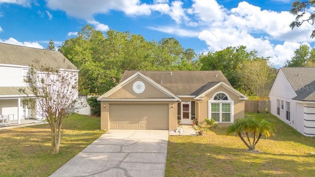 1002 Kelsey Ave, Oviedo, FL 32765 - view of front of home featuring stucco siding, fence, driveway, a front yard, and a garage