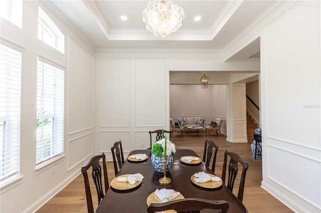 25813 Feather Ridge Ln, Sorrento, FL 32776 - dining space with a decorative wall, healthy amount of natural light, stairs, light wood finished floors, and a chandelier