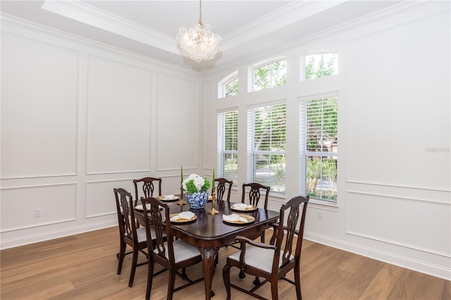 25813 Feather Ridge Ln, Sorrento, FL 32776 - dining space featuring a decorative wall, light wood-type flooring, a chandelier, and ornamental molding