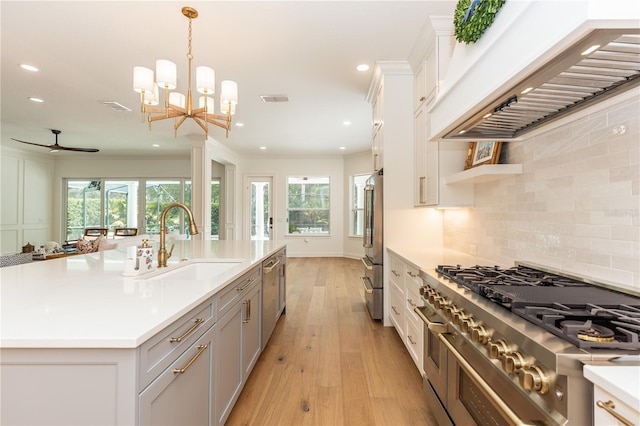 25813 Feather Ridge Ln, Sorrento, FL 32776 - kitchen with premium range hood, a sink, recessed lighting, light countertops, and decorative backsplash