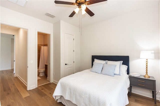 25813 Feather Ridge Ln, Sorrento, FL 32776 - bedroom featuring wood finished floors, baseboards, ensuite bathroom, and a ceiling fan