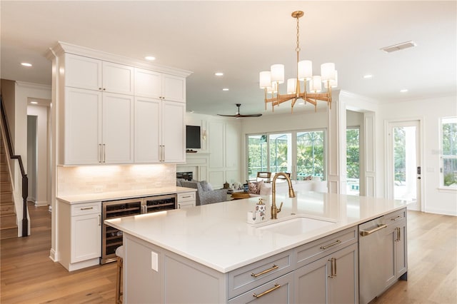 25813 Feather Ridge Ln, Sorrento, FL 32776 - kitchen featuring wine cooler, light wood-style floors, a chandelier, healthy amount of natural light, and recessed lighting