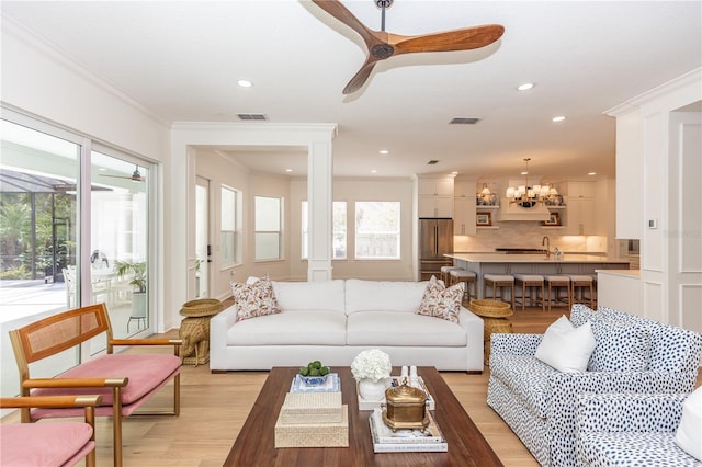 25813 Feather Ridge Ln, Sorrento, FL 32776 - living room featuring light wood finished floors, ceiling fan, a chandelier, ornamental molding, and recessed lighting