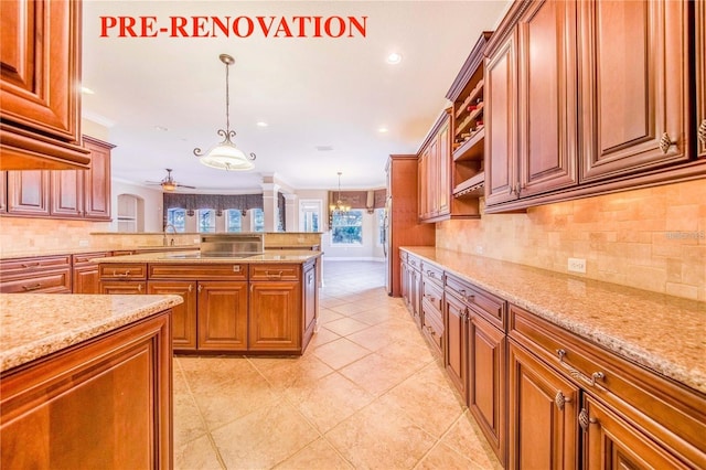 25813 Feather Ridge Ln, Sorrento, FL 32776 - kitchen with tasteful backsplash, a ceiling fan, recessed lighting, brown cabinets, and hanging light fixtures