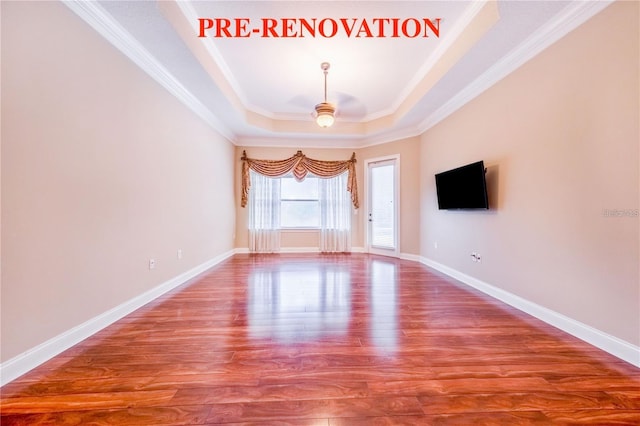 25813 Feather Ridge Ln, Sorrento, FL 32776 - empty room featuring a raised ceiling, wood finished floors, ceiling fan, and ornamental molding