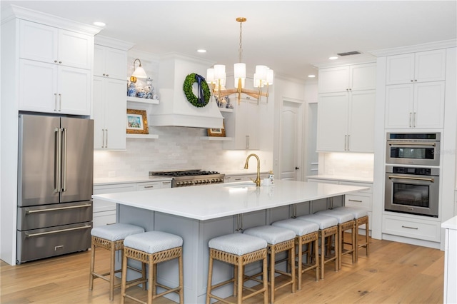 25813 Feather Ridge Ln, Sorrento, FL 32776 - kitchen with appliances with stainless steel finishes, light wood-style floors, backsplash, light countertops, and recessed lighting