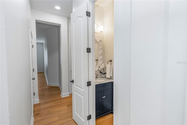 25813 Feather Ridge Ln, Sorrento, FL 32776 - hallway featuring light wood-style floors and recessed lighting