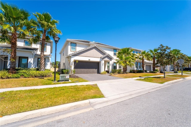 2659 Calistoga Ave, Kissimmee, FL 34741 - view of front of home featuring driveway, stucco siding, a front lawn, and a garage