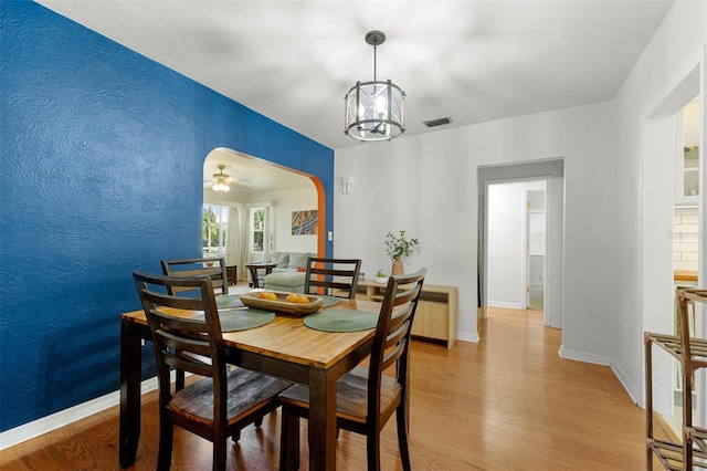 926 Mayfair Cir, Orlando, FL 32803 - dining area featuring baseboards, visible vents, a chandelier, and light wood-type flooring