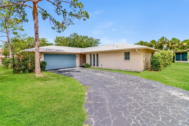 4337 Marine Pkwy, New Port Richey, FL 34652 - ranch-style house with driveway, a front yard, french doors, stucco siding, and a garage