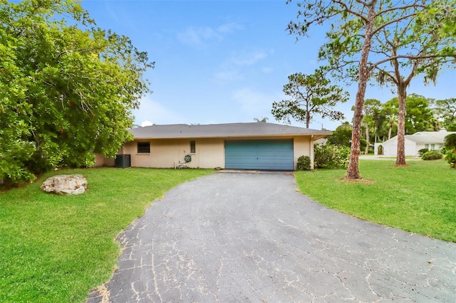 4337 Marine Pkwy, New Port Richey, FL 34652 - ranch-style home featuring a front lawn, stucco siding, an attached garage, and aphalt driveway