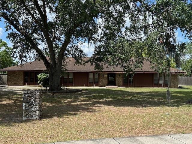 1500 Markham Woods Rd, Longwood, FL 32779 - ranch-style home featuring fence and a front lawn