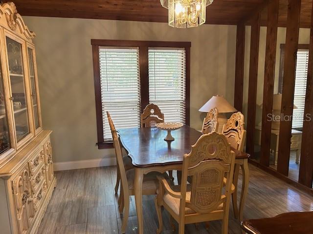 1500 Markham Woods Rd, Longwood, FL 32779 - dining space with an inviting chandelier, plenty of natural light, baseboards, and wood finished floors