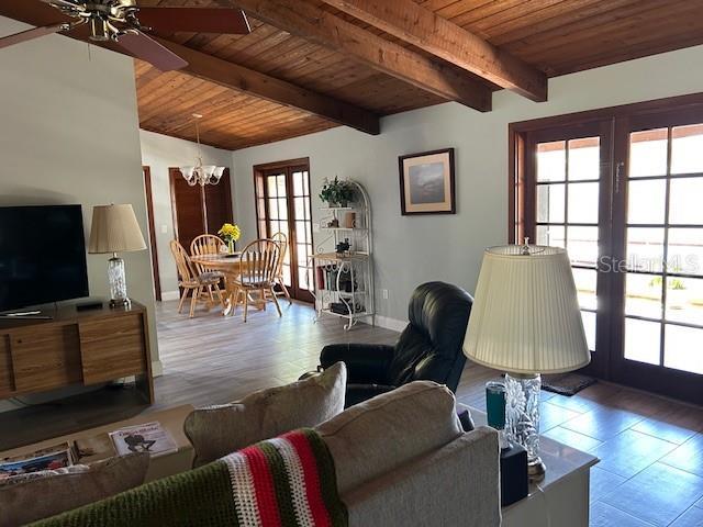 1500 Markham Woods Rd, Longwood, FL 32779 - living area featuring wooden ceiling, french doors, baseboards, ceiling fan with notable chandelier, and beamed ceiling