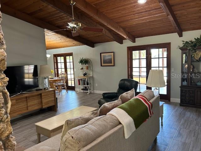 1500 Markham Woods Rd, Longwood, FL 32779 - living room with beamed ceiling, a ceiling fan, wood finished floors, and wooden ceiling