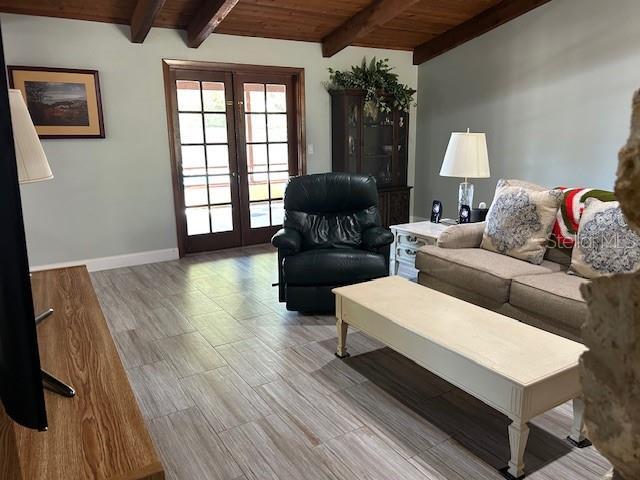 1500 Markham Woods Rd, Longwood, FL 32779 - living room with french doors, wooden ceiling, baseboards, and beamed ceiling