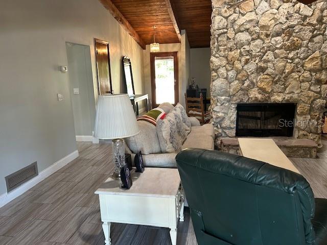 1500 Markham Woods Rd, Longwood, FL 32779 - living room with visible vents, baseboards, wood finished floors, vaulted ceiling with beams, and wooden ceiling