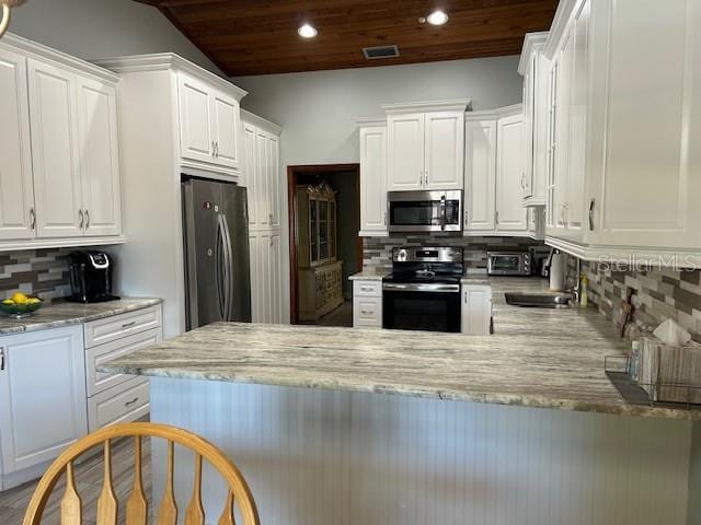 1500 Markham Woods Rd, Longwood, FL 32779 - kitchen with white cabinetry, wooden ceiling, a sink, visible vents, and appliances with stainless steel finishes