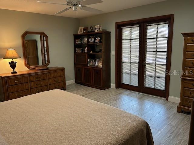 1500 Markham Woods Rd, Longwood, FL 32779 - bedroom with baseboards, light wood-style floors, and a ceiling fan