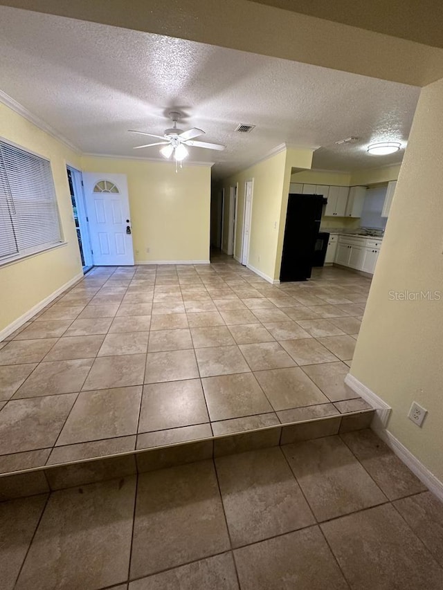 6427 Breezewood St, Orlando, FL 32818 - interior space featuring a ceiling fan, light tile patterned floors, baseboards, and a textured ceiling