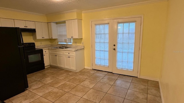 6427 Breezewood St, Orlando, FL 32818 - kitchen with crown molding, under cabinet range hood, white cabinetry, a sink, and black appliances