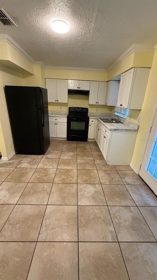 6427 Breezewood St, Orlando, FL 32818 - kitchen with light tile patterned flooring, light countertops, visible vents, ornamental molding, and black appliances