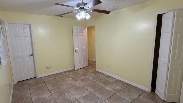 6427 Breezewood St, Orlando, FL 32818 - unfurnished bedroom with a ceiling fan, light tile patterned flooring, baseboards, and visible vents