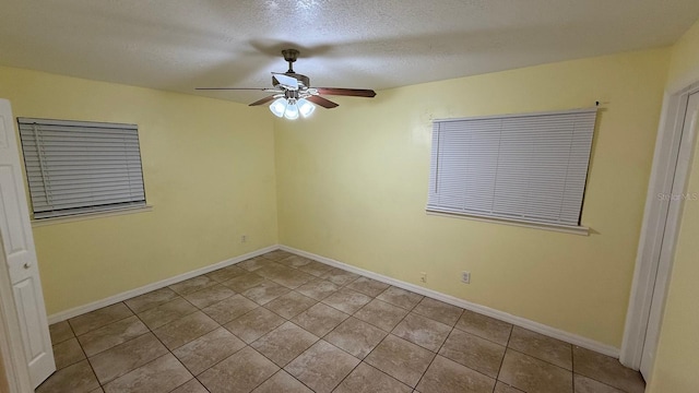 6427 Breezewood St, Orlando, FL 32818 - tiled spare room with baseboards, a textured ceiling, and a ceiling fan
