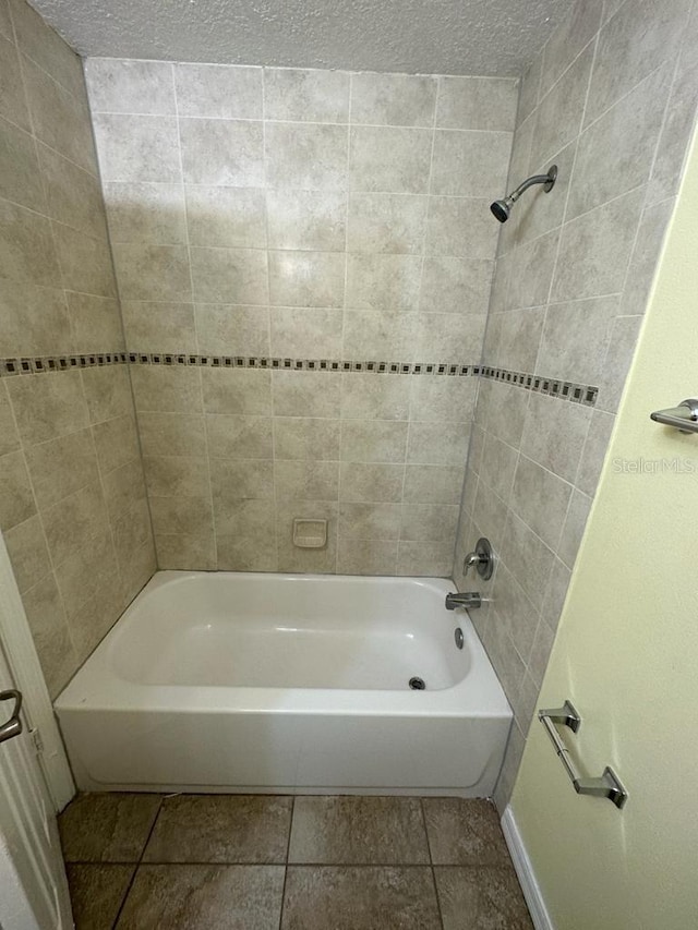 6427 Breezewood St, Orlando, FL 32818 - full bath with tile patterned flooring, shower / tub combination, and a textured ceiling