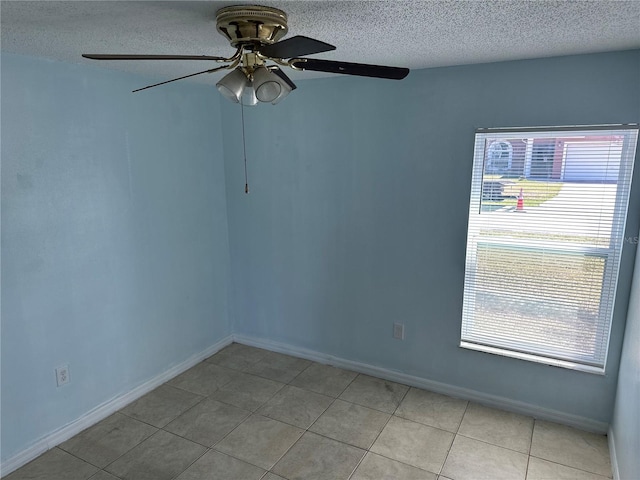 214 Magellan Dr, Kissimmee, FL 34758 - empty room featuring a ceiling fan, light tile patterned flooring, a textured ceiling, and a wealth of natural light
