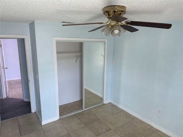 214 Magellan Dr, Kissimmee, FL 34758 - unfurnished bedroom with a closet, a textured ceiling, visible vents, tile patterned floors, and a ceiling fan