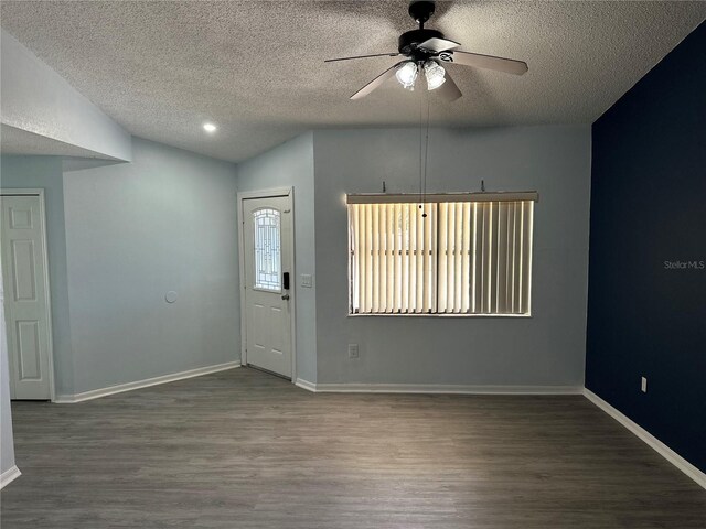 214 Magellan Dr, Kissimmee, FL 34758 - entrance foyer with vaulted ceiling, wood finished floors, a textured ceiling, baseboards, and ceiling fan