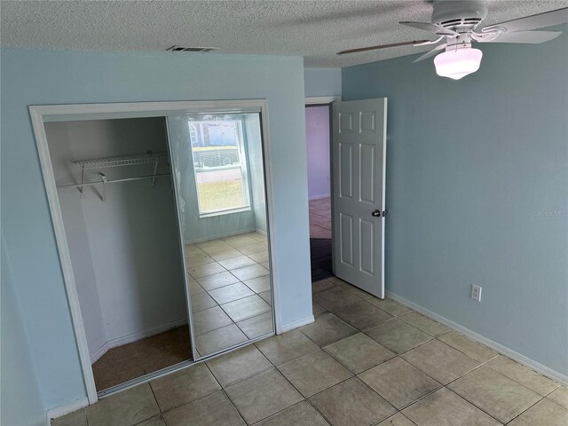 214 Magellan Dr, Kissimmee, FL 34758 - unfurnished bedroom featuring a closet, a textured ceiling, visible vents, and tile patterned floors