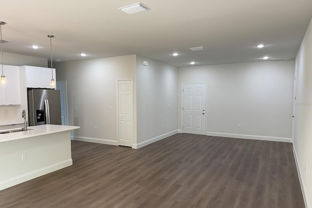 8830 N Salina Dr, Citrus Springs, FL 34434 - kitchen with stainless steel refrigerator with ice dispenser, recessed lighting, dark wood-type flooring, light countertops, and white cabinets