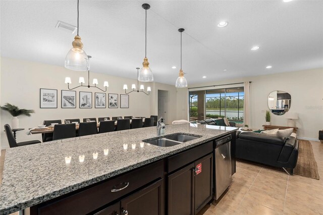 kitchen with visible vents, a center island with sink, a sink, open floor plan, and stainless steel dishwasher