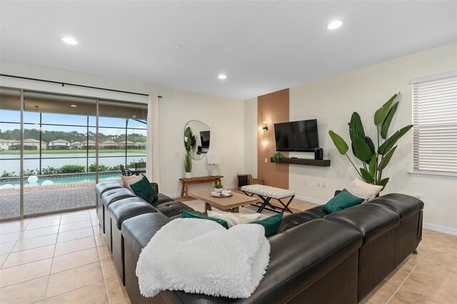 living area featuring light tile patterned floors, baseboards, and recessed lighting