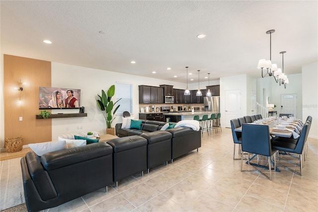 living area with light tile patterned flooring, a textured ceiling, and recessed lighting