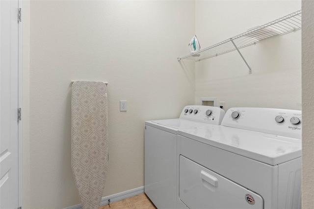 laundry room featuring independent washer and dryer, laundry area, baseboards, and light tile patterned floors