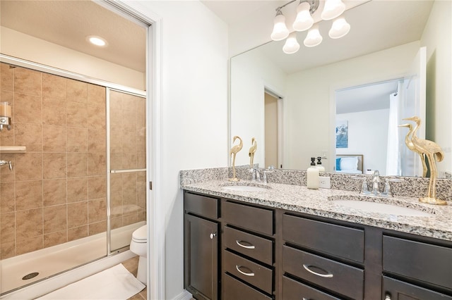 bathroom with a sink, toilet, and a shower stall