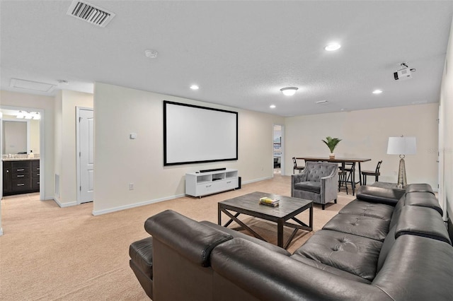 cinema with recessed lighting, baseboards, a textured ceiling, visible vents, and light carpet