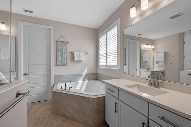 2011 Soaring Oak Way, Winter Park, FL 32792 - full bath with a garden tub, visible vents, tile patterned flooring, and vanity
