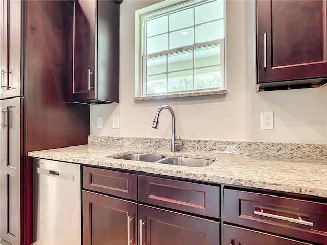 509 Mulberry St, Fruitland Park, FL 34731 - kitchen featuring stainless steel dishwasher, light stone countertops, and a sink