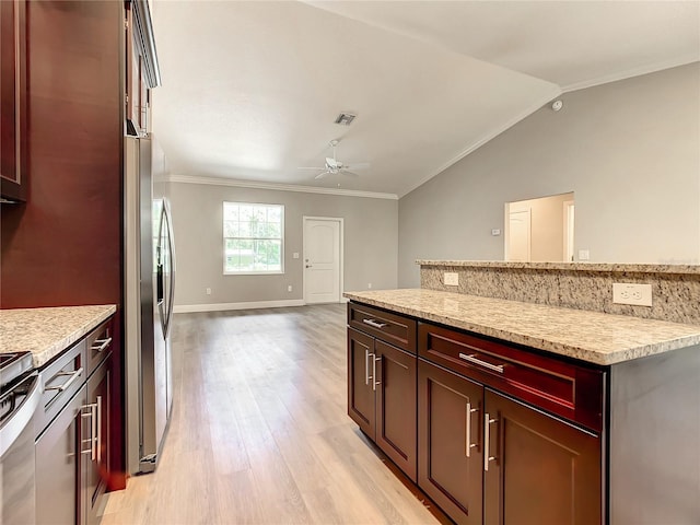 509 Mulberry St, Fruitland Park, FL 34731 - kitchen featuring stainless steel fridge, crown molding, ceiling fan, lofted ceiling, and light wood-style floors